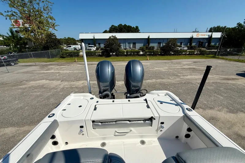 Slide: The Image of 2022 Blue Wave 2800 Makaira boat with dual engines in a parking lot. - 12