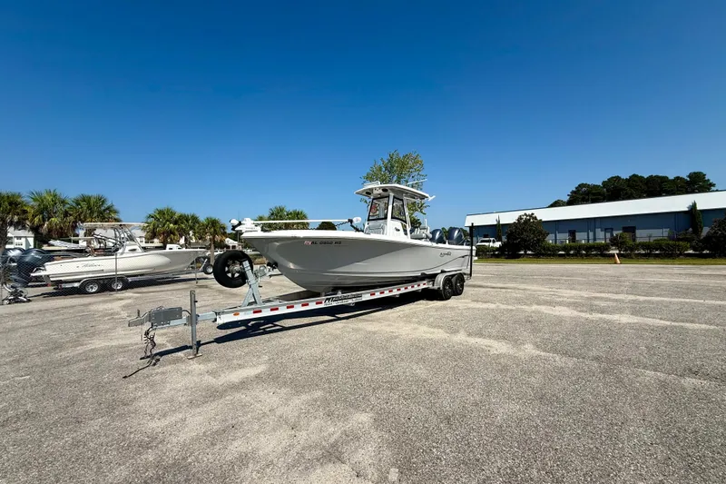 Slide: The Image of 2022 Blue Wave 2800 Makaira boat on trailer in sunny outdoor setting. - 2