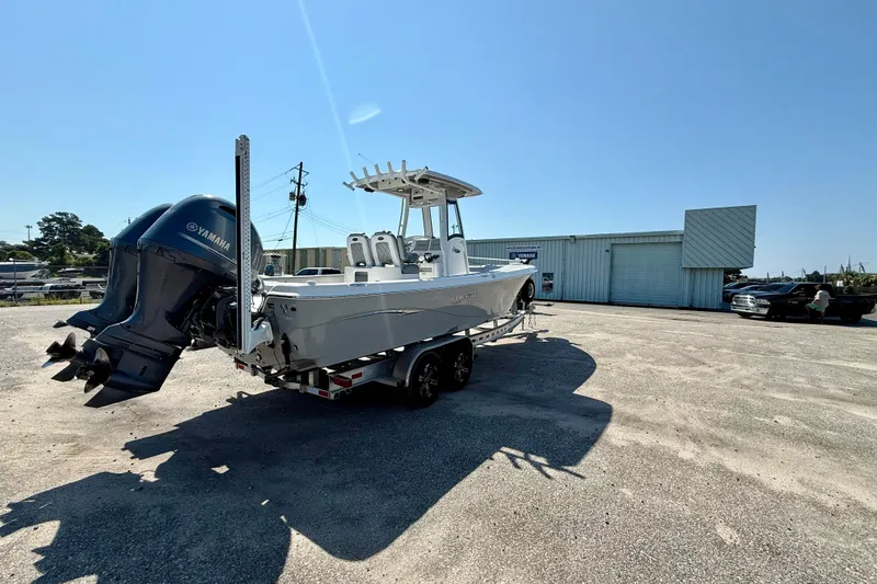 Slide: The Image of 2022 Blue Wave 2800 Makaira boat with Yamaha engines on a trailer in a parking lot. - 3
