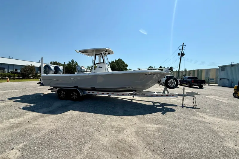 Slide: The Image of 2022 Blue Wave 2800 Makaira boat on trailer in sunny outdoor setting. - 4