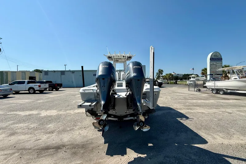 Slide: The Image of 2022 Blue Wave 2800 Makaira boat with dual Yamaha engines in a parking lot. - 5