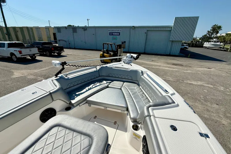 Slide: The Image of 2022 Blue Wave 2800 Makaira boat with spacious seating, parked outdoors. - 7