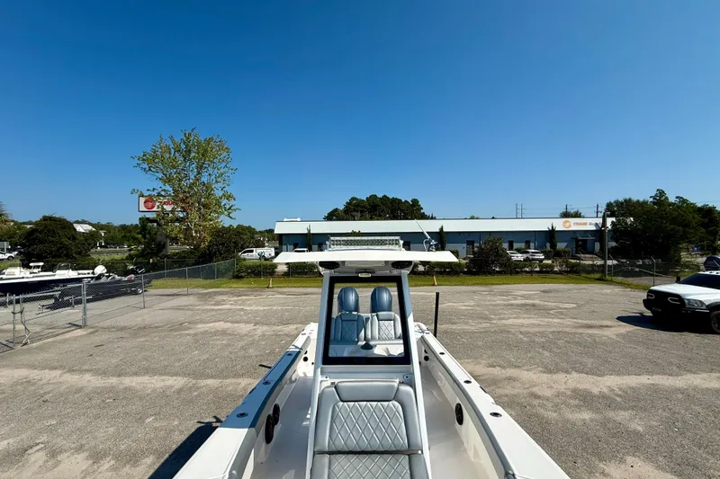 Slide: The Image of 2022 Blue Wave 2800 Makaira boat parked in a lot under clear blue sky. - 8