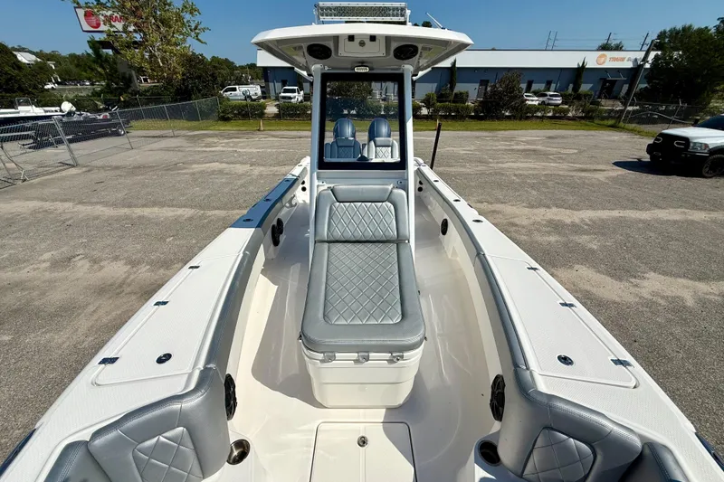 Slide: The Image of 2022 Blue Wave 2800 Makaira boat interior with gray seating and spacious deck. - 9