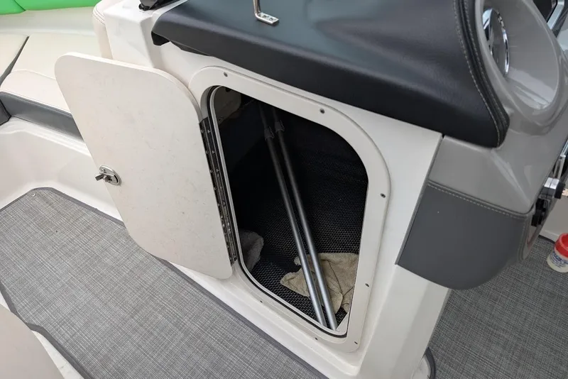 Slide: The Image of 2018 Chaparral Vortex 203 VRX boat storage compartment with open door and interior view. - 15