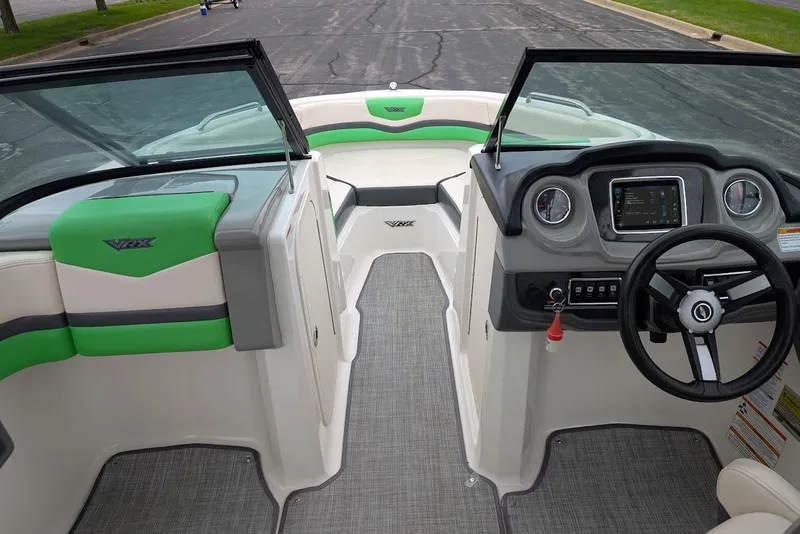 Slide: The Image of 2018 Chaparral Vortex 203 VRX boat interior with green accents and modern dashboard. - 20