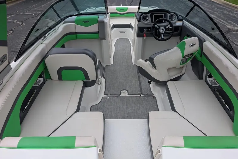 Slide: The Image of 2018 Chaparral Vortex 203 VRX boat interior with green and white seating, modern dashboard. - 22