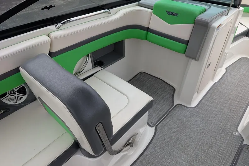 Slide: The Image of 2018 Chaparral Vortex 203 VRX interior with green and gray seating, modern design. - 24