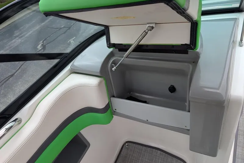 Slide: The Image of 2018 Chaparral Vortex 203 VRX boat interior storage compartment with green and gray accents. - 25