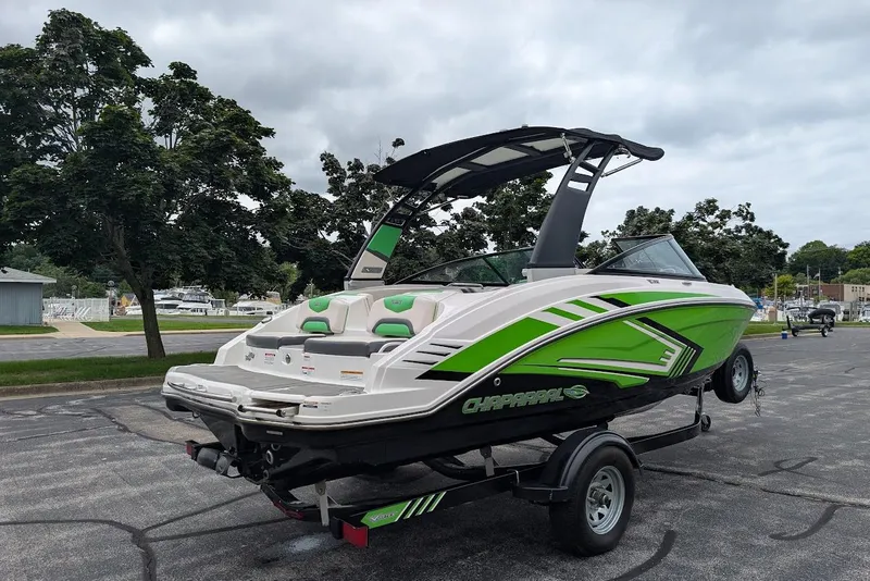 Slide: The Image of 2018 Chaparral Vortex 203 VRX boat with green accents on a trailer, parked outdoors. - 5