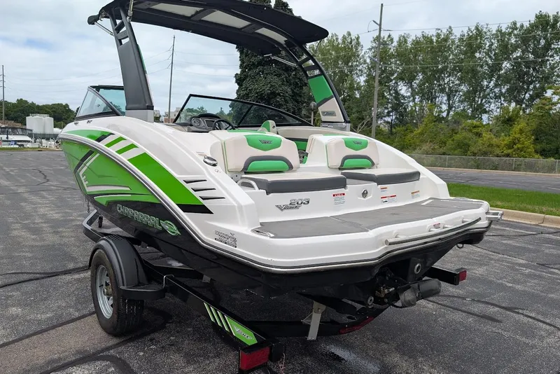 Slide: The Image of 2018 Chaparral Vortex 203 VRX boat with green accents on a trailer. - 7
