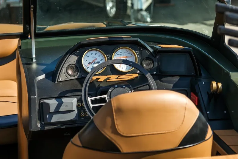 Slide: The Image of Dashboard of 2022 MB B52 23 Alpha boat with tan leather seats and modern controls. - 10