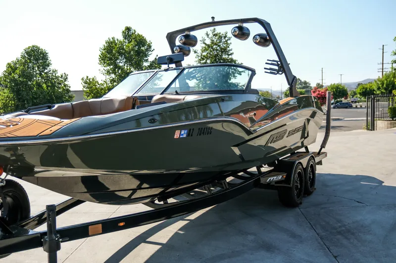 Slide: The Image of 2022 MB B52 23 Alpha boat on trailer, sleek design, parked outdoors. - 22