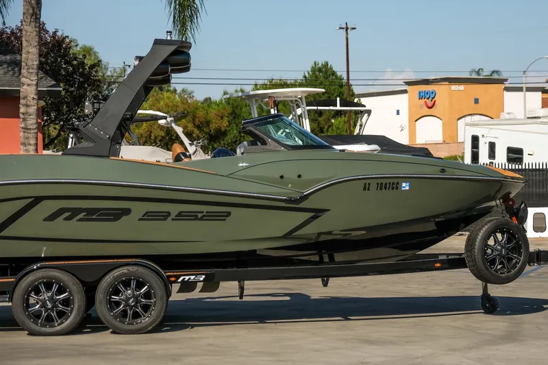 Slide: The Image of 2022 MB B52 23 Alpha boat on trailer, parked outdoors. - 3