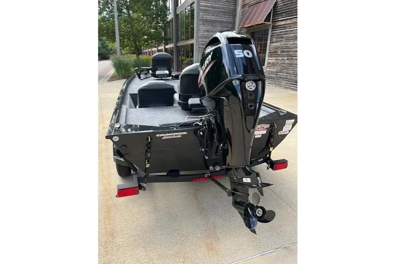 Slide: The Image of 2025 Tracker PRO170 boat with Mercury 50 engine, parked outdoors. - 2