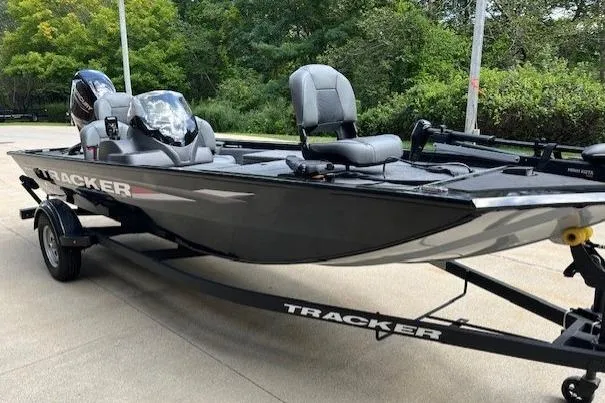 Slide: The Image of 2025 Tracker PRO170 fishing boat on trailer, parked outdoors. - 3