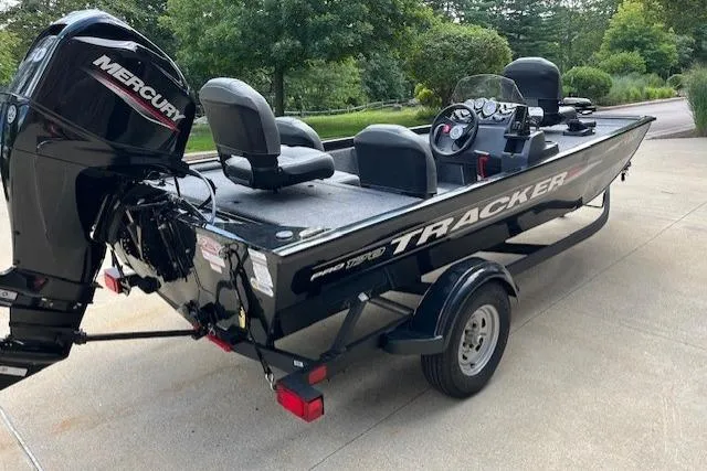 Slide: The Image of 2025 Tracker PRO170 boat with Mercury engine on trailer, parked outdoors. - 4