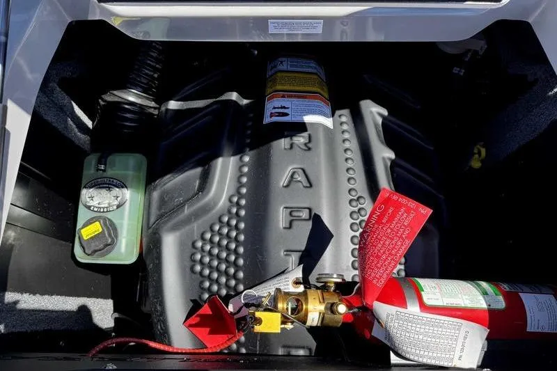 Slide: The Image of Engine compartment of 2026 Supra SA with visible fire extinguisher and components. - 10