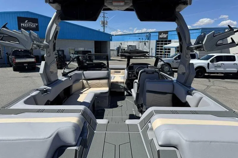 Slide: The Image of 2026 Supra SA boat interior with modern seating and dashboard, parked at a dealership. - 3