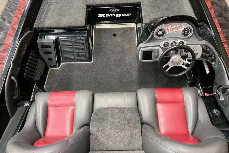 Slide: The Image of 2008 Ranger 188VX Comanche boat interior with red and gray seats, steering wheel, and dashboard. - 6