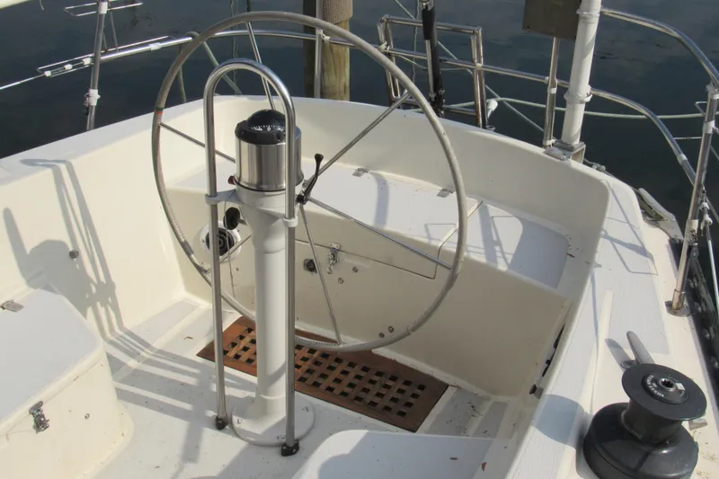 Slide: The Image of Steering wheel of a 1976 Tartan 3800 sailboat, featuring a classic nautical design. - 14
