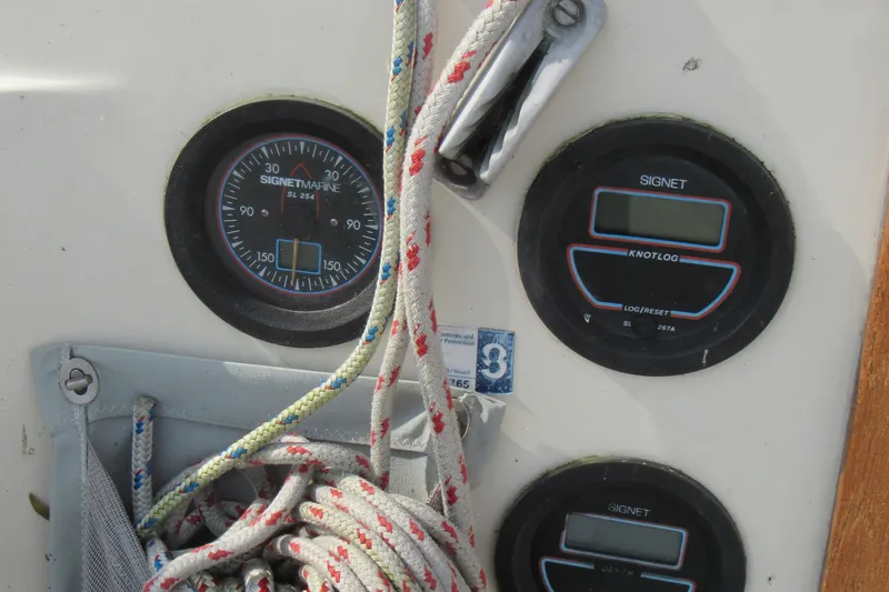 Slide: The Image of Control panel of a 1976 Tartan 3800 sailboat with gauges and ropes. - 17