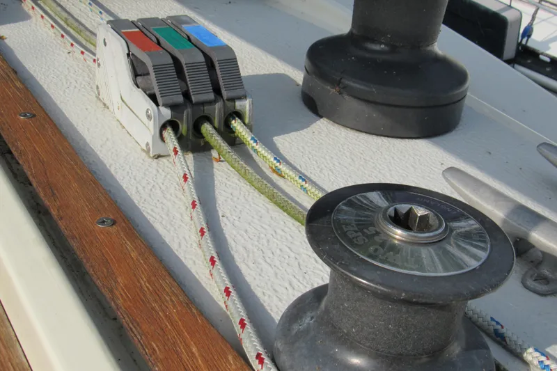 Slide: The Image of Deck of 1976 Tartan 3800 sailboat with rope clutches and winch. - 19