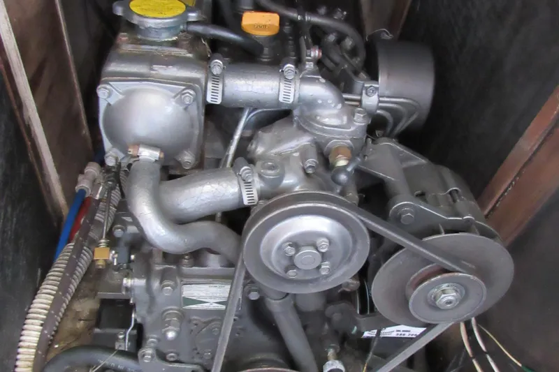 Slide: The Image of 1976 Tartan 3800 engine with visible belts and hoses in a compact space. - 20