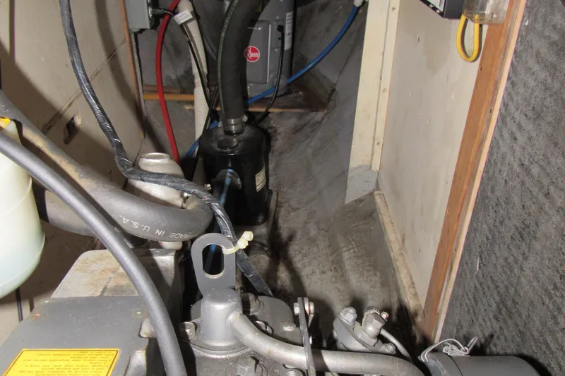 Slide: The Image of Engine compartment of a 1976 Tartan 3800 sailboat, showing mechanical components and wiring. - 21