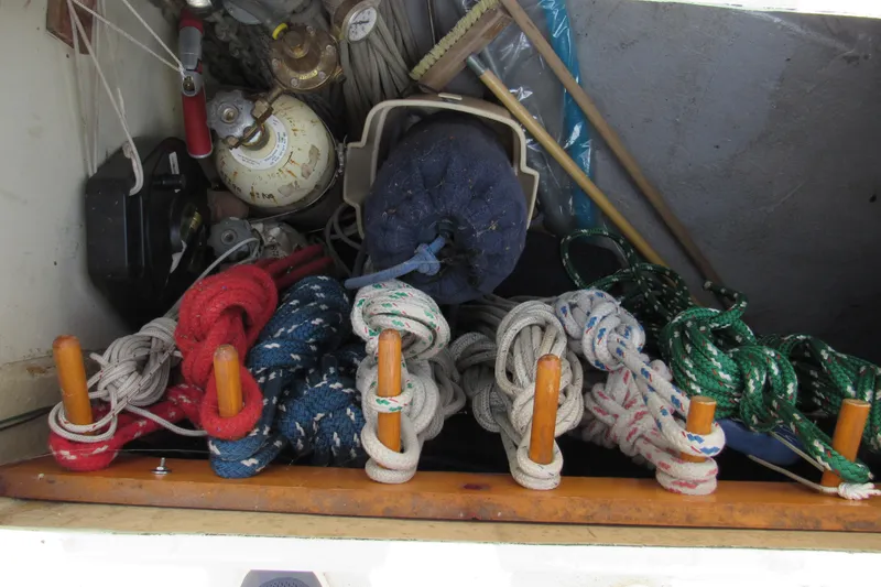 Slide: The Image of Storage compartment with colorful ropes and equipment on a 1976 Tartan 3800 sailboat. - 23