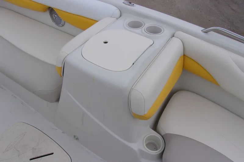 Slide: The Image of 2009 Tahoe 195 I/O boat interior with white and yellow seating and cup holders. - 11