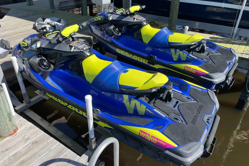 Slide: The Image of 2020 Sea-Doo Wake Pro 230 jet skis docked, featuring vibrant blue and yellow design. - 5