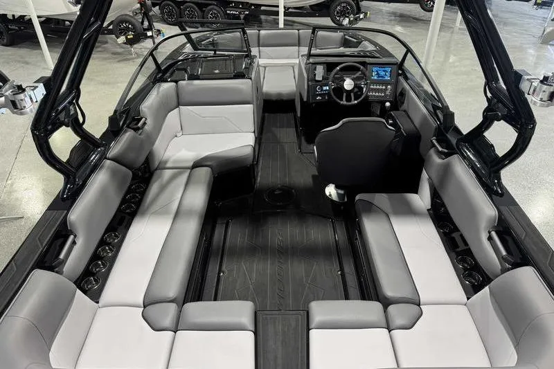 Slide: The Image of 2026 Moomba Max boat interior with spacious seating and modern dashboard. - 11