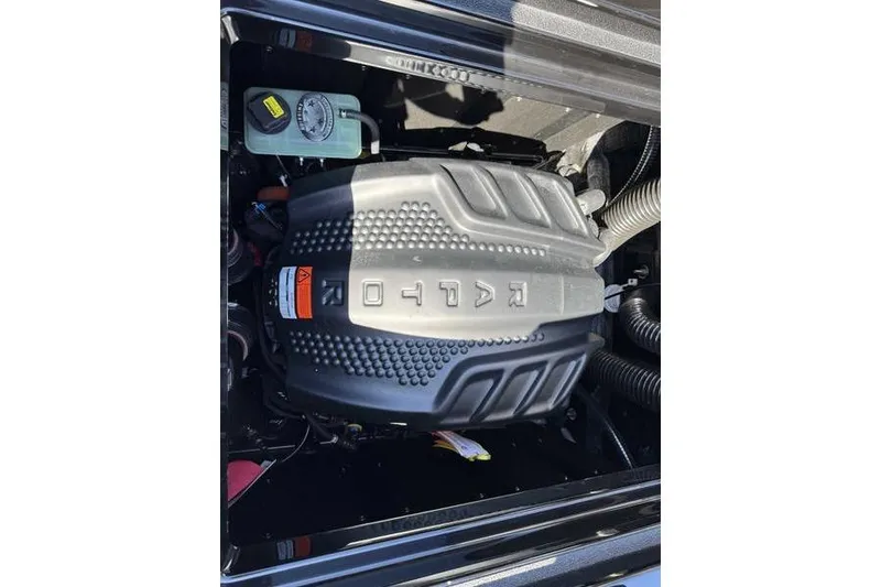 Slide: The Image of 2026 Moomba Max engine compartment with detailed cover and visible components. - 12