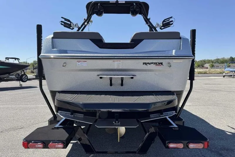 Slide: The Image of 2026 Moomba Max boat rear view in a parking lot, showcasing Raptor engine. - 5