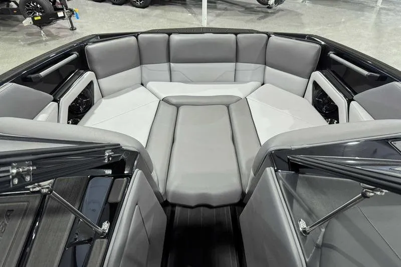 Slide: The Image of 2026 Moomba Max boat interior with gray seating and spacious layout. - 9