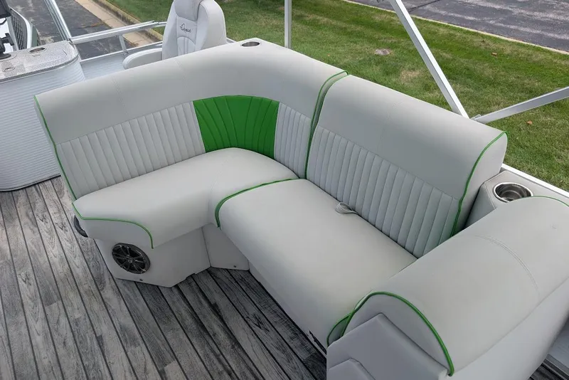 Slide: The Image of 2021 Qwest LS 822 DS Bar boat seating with green accents on wooden deck. - 23