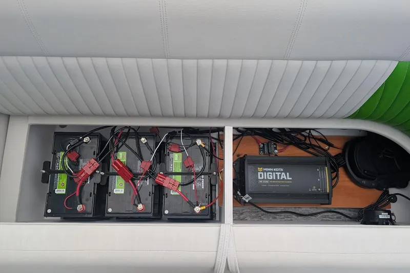 Slide: The Image of 2021 Qwest LS 822 DS Bar boat battery and Minn Kota digital charger setup. - 26
