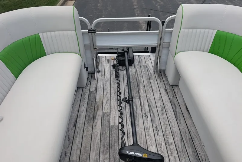 Slide: The Image of 2021 Qwest LS 822 DS Bar boat interior with green and white seating, wooden deck. - 30