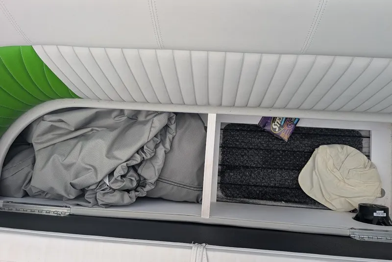 Slide: The Image of Storage compartment in 2021 Qwest LS 822 DS Bar boat with cover and cleaning supplies. - 31