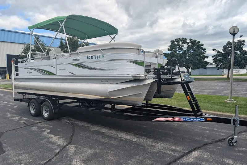 Slide: The Image of 2021 Qwest LS 822 DS Bar pontoon boat on trailer, parked outdoors. - 4