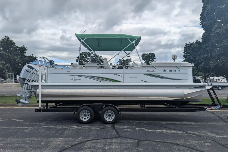 Slide: The Image of 2021 Qwest LS 822 DS Bar pontoon boat on trailer, featuring green canopy. - 5
