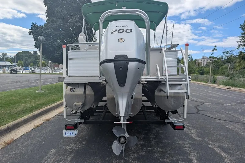 Slide: The Image of 2021 Qwest LS 822 DS Bar pontoon boat with Honda 200 engine, parked on a trailer. - 7