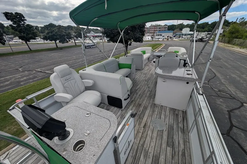 Slide: The Image of 2021 Qwest LS 822 DS Bar pontoon boat with green canopy and spacious seating. - 9