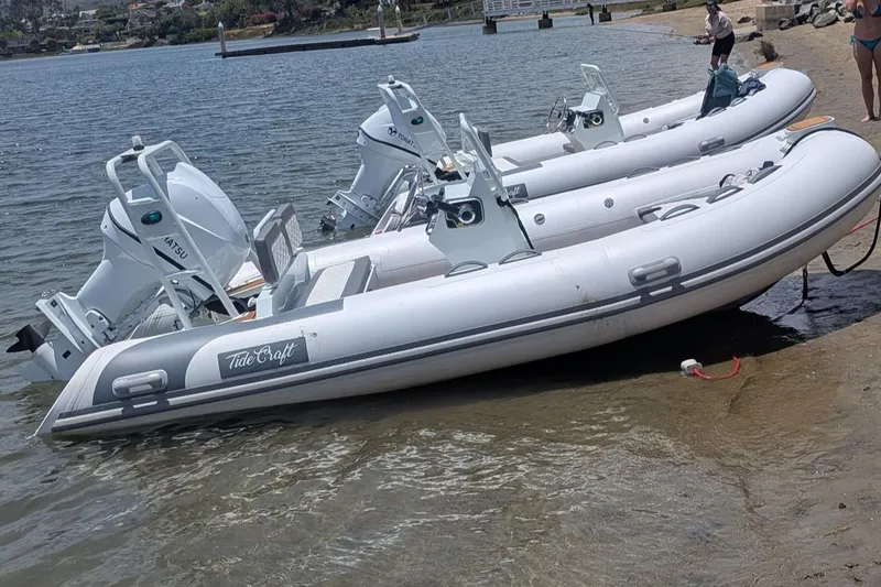 Slide: The Image of Three Tide Craft Catalina 13-Hypalon boats on a sandy shore, 2026 model. - 10