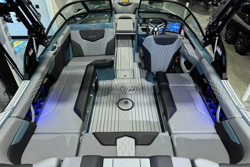 Slide: The Image of 2026 MasterCraft XT23 boat interior with modern seating and advanced dashboard technology. - 19