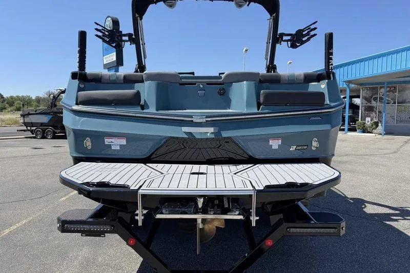 Slide: The Image of 2026 MasterCraft XT23 boat rear view, featuring sleek design and modern amenities. - 4