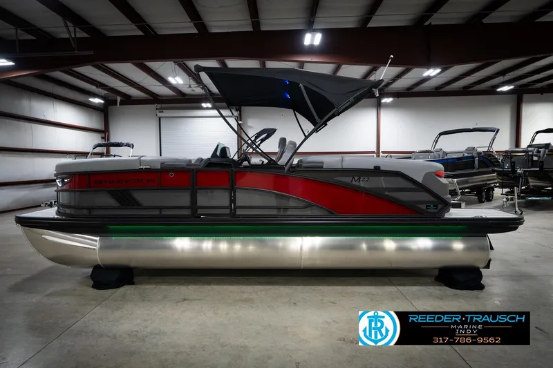 Slide: The Image of 2026 Bennington 22 MFB pontoon boat in showroom with canopy and sleek design. - 10
