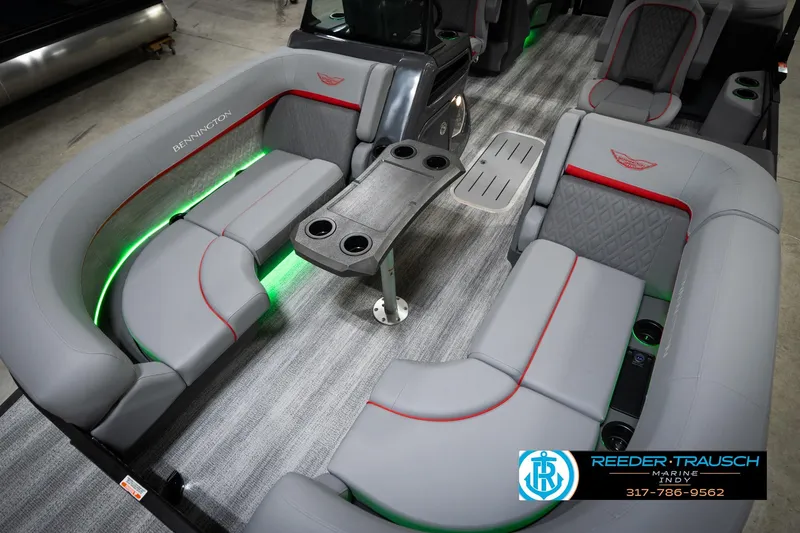 Slide: The Image of Luxurious interior of 2026 Bennington 22 MFB pontoon boat with gray seating and green lighting. - 11