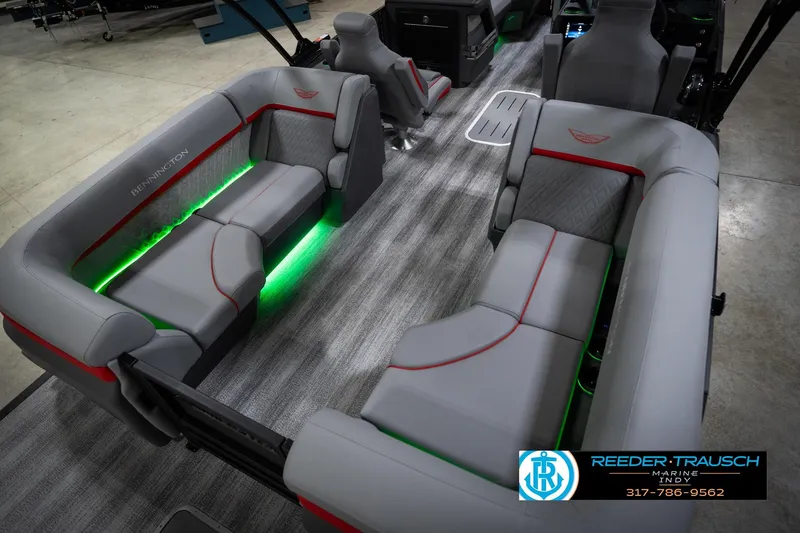 Slide: The Image of 2026 Bennington 22 MFB boat interior with gray seating, green LED lighting, and modern design. - 13